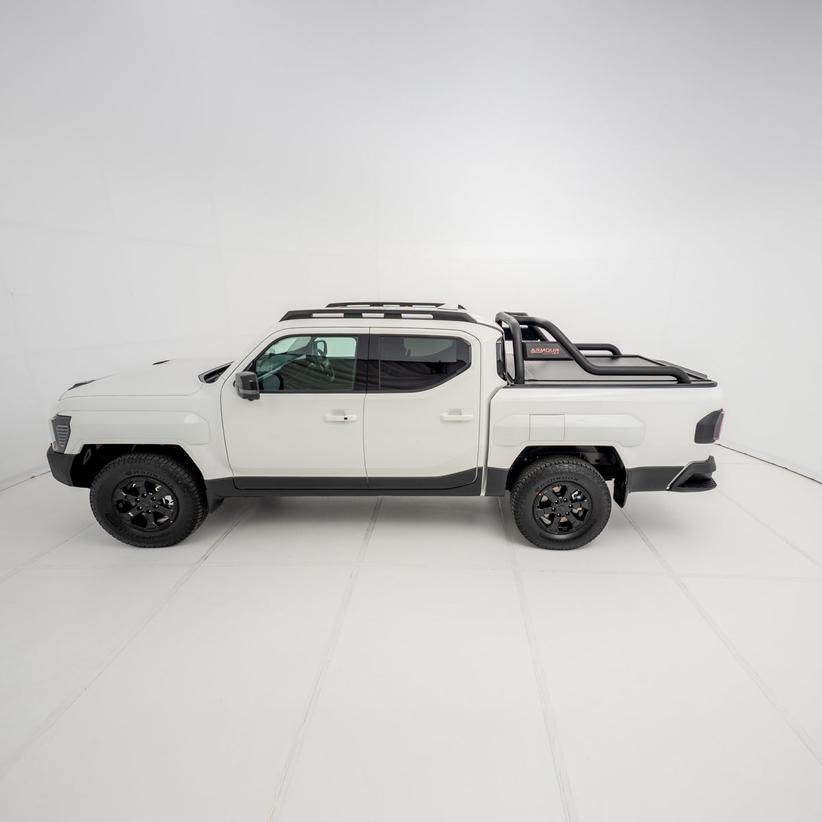 Three-quarter side view of a white Kia Tasman with the HSP Roll R electric roller cover installed, highlighting the closed roller shutter and curved black sports bars positioned over the tub.