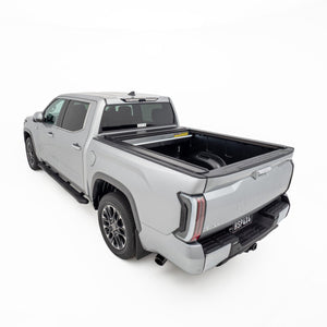 Rear three quarter view of silver Toyota Tundra with open HSP Roller Cover fitted over tub