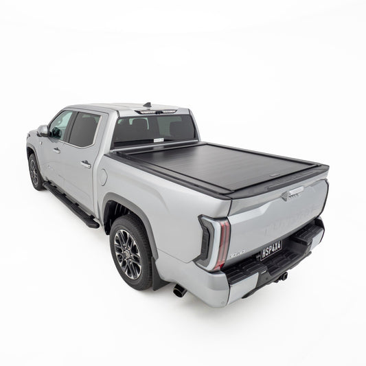 Rear three quarter view of silver Toyota Tundra showing closed HSP Roller Cover